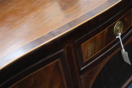 A George III crossbanded mahogany serpentine sideboard, W.6ft 1in. D.2ft 2ihn. H.3ft